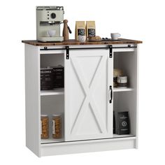 a white cabinet with an open door on the top and shelves below it, next to a coffee maker