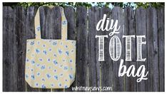 the diy tote bag is hanging up against a wooden fence with blue flowers on it