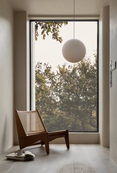 a chair sitting in front of a large window