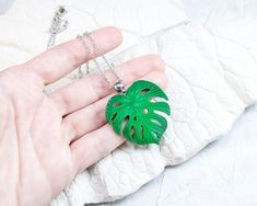 Monstera Tropical Leaf necklace. Green palm leaf pendant - good choice for summer, rest and having fun. This tropical necklace will be nice gift for her, especially if she's monstera leaf lover. Leaf are handmade from polymer clay, not fragile, not afraid of water, do not change color with time. READY TO SHIP 🍃 Dimensions: Size of leaf 1.38 * 1.38 inches (3.5 * 3.5 cm) The length of the chain to choose from when placing an order 🍃 Materials: - Polymer clay - Stainless steel (not darken) ❀ All Trendy Green Charm Necklace For Gift, Trendy Green Charm Necklace Perfect For Gifts, Trendy Leaf-shaped Jewelry Gift, Handmade Tropical Green Jewelry, Green Leaf-shaped Necklace For Gift, Tropical Necklace, Necklace Green, Tropical Leaf, Monstera Leaf