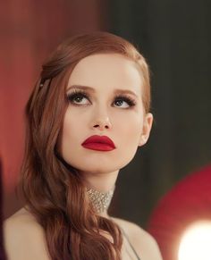 a woman with long hair and red lipstick