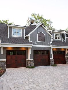 a large house with two garages on each side