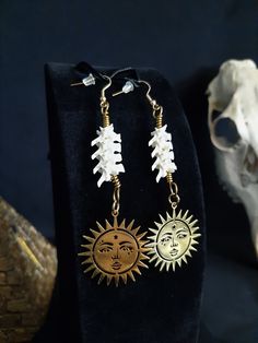 Here are some Beautiful Golden Steel Sun earrings! They Were Made with Real Rattlesnake Vertebrae. These Earrings are Around 4 Inches Long. The Hooks and Pendants Are Gold Stainless Steel. All Items Ship Within 1-3 Days via USPS First Class Service. Shipping on These Earrings Will be 5.00 Additional Items are Free! International Shipping Will Be 20.00, And All Additional Items Are FREE! International Shipping May Take 2 - 6 Weeks To Deliver. I Always Love to Accommodate Custom Orders! If you Hav White Brass Jewelry For Festival, White Spiritual Pierced Jewelry, Symbolic White Jewelry For Festivals, Bone Colored Earrings With Ear Wire For Gift, Handmade Metal Jewelry In Bone Color, Nickel-free Bone Colored Jewelry As Gift, Unique Brass Jewelry In Bone Color, Bone Color Dangle Earrings With Ear Wire, Bohemian Bone-colored Pierced Earrings