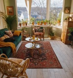 a living room filled with furniture and lots of plants in the window sills