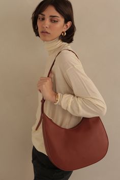 Soft, semi-structured, versatile and perfectly spacious. The classic Hobo shape was redesigned with an adjustable strap in two easy neutrals that will pair with just about everything. Details 12.5" L x 11" H x 4.5" D Zipper Closure ADJUSTABLE STRAP Gold hardware Everyday Pebbled Leather Hobo Bag With Adjustable Strap, Pebbled Leather Hobo Bag With Removable Pouch For On-the-go, Pebbled Leather Hobo Shoulder Bag With Gold-tone Hardware, Pebbled Leather Crossbody Hobo Bag With Gold-tone Hardware, On-the-go Crossbody Hobo Bag With Detachable Handle, Casual Date Night, Hook Necklace, Detailed Necklace, Mini Studs