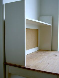 an empty room with white walls and wood flooring is seen from the inside out