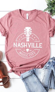 Nashville Music City Graphic Tee. Most t-shirt colors are 52/48 Airlume combed and ringspun cotton/polyester, Athletic Heather & Black Heather are 90/10 airlume combed and ringspun cotton/polyester. White, cream, canvas red, lilac, mint are 100% cotton. Music Festival Graphic Tee T-shirt Soft-washed, Graphic Tee For Music Festival, Soft-washed, Soft-washed Crew Neck T-shirt For Music Festival, Cotton T-shirt With Screen Print For Music Festival, Music-themed Cotton T-shirt With Relaxed Fit, Pre-shrunk Music-themed T-shirt For Summer, Crew Neck Cotton T-shirt For Music Festival, Cotton Crew Neck T-shirt For Music Festival, Cotton T-shirt For Concert