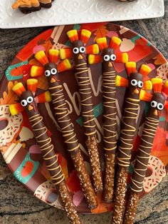 a plate with candy sticks decorated like turkeys