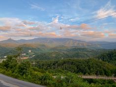 a scenic view of the mountains and trees from an overlook point on a cloudy day