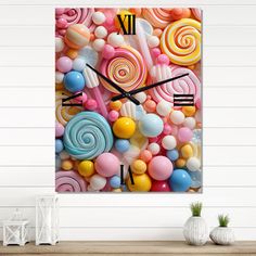 a wall clock with candy and lollipops on it in front of a wooden table