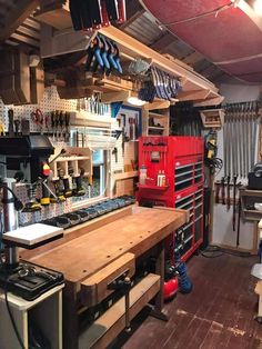 a workbench with tools hanging from the ceiling