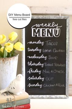 a chalkboard menu with yellow tulips in a white vase on top of books