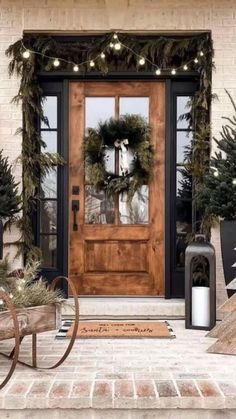 a front door decorated for christmas with wreaths and lights