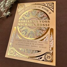 a gold foiled wedding card with an intricate design on the front and back cover