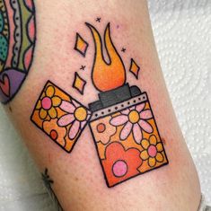 a tattoo on the leg of a woman with a lighter in it's flame