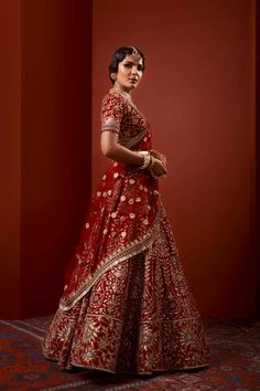 Heavy Red Lehenga Bridal in Thread Embroidery is emblazoned in Swarovski crystals and paired with a magnificent red lehenga/gharara in velvet decorated with minute thread details and a heavily embroidered dupatta. Choli: This heavy bridal lehenga comes in thread embroidery in white color with red velvet base and heavily embellished neckline and heavily embroidered sleeve, finished with a side zip closure. Lehenga: It is paired with a trailed self-jamavar lehnga, heavily embellished around its flare. Pakistani Red Lehenga Bridal Choli is paired with sequins, thread, and tilla print embellishments that are a perfect choice to wear on a big day. The perfect combo of white and red creates a Dreamy Bridal Attire for your Wedding Day. Dupatta: This beautiful Red Velvet base Lehenga Choli sets a Red Bollywood Lehenga With Meenakari Details, Bollywood Red Sharara With Meenakari, Red Meenakari Sharara For Reception, Anarkali Style Red Meenakari Choli, Red Choli With Meenakari And Kundan, Red Meenakari Anarkali Choli, Red Meenakari Choli For Reception, Red Meenakari Sharara For Festivals, Red Sharara With Meenakari In Traditional Drape