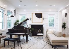 a living room filled with furniture and a piano