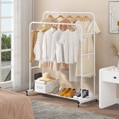 a white rack with clothes and shoes on it in a bedroom next to a bed