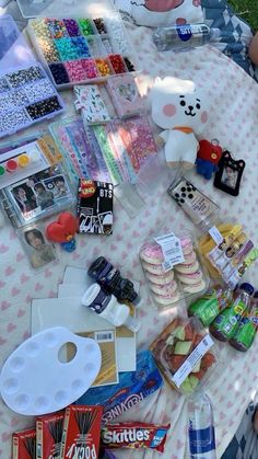 an assortment of candy, candies and other items on a picnic table with teddy bears