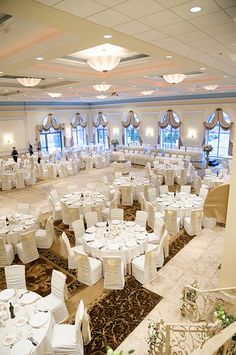 a banquet hall with tables and chairs set up for an event