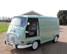 an old green van parked on the side of a road