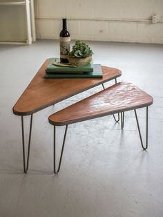 two wooden tables sitting on top of each other in front of a bottle of wine