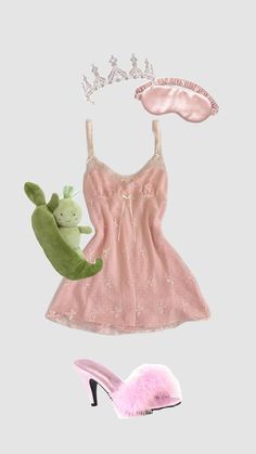 a pink dress and shoes are hanging on a clothesline with a green stuffed animal