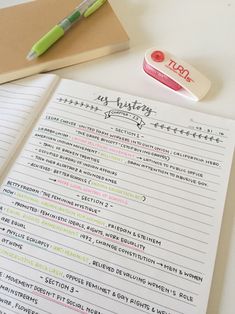 an open notebook with writing on it next to a pen and sticky notepads