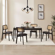 a dining room table with four chairs around it