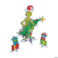 the grinch is holding a christmas tree and presents