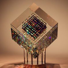 a glass sculpture with multicolored lights on it