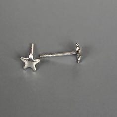 A PAIR of tiny sterling silver star ear studs. Size: 5 x 5 mm. Weight: 0.46gm Price listed is for a PAIR of studs. These earrings are made of 925 hypoallergenic sterling silver Can be packaged in a gift box. I can include a personal message from you if needed You are welcome to contact me at... bhavnakwintra1956@gmail.com For more beautiful pieces from my shop, please browse 👇 TOE RINGS: https://www.etsy.com/your/shops/TheSilverGame/tools/listings/section:27020628,view:table EAR HOOPS: https:// Nickel-free Star-shaped Silver Piercings, Nickel Free Silver Star-shaped Piercing, Nickel-free Silver Star Piercings, Minimalist Silver Star Piercings, Silver Star Single Stud Earring, Sterling Silver Star-shaped Piercings, Sterling Silver Star Piercings In Silver, Silver Star-shaped Sterling Silver Piercings, Silver Star Shaped Internally Threaded Piercings