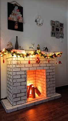 a brick fireplace with christmas lights on it