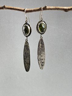 Vesuviantie is a beautiful stone with it's rich warm green color and it's interesting characteristics. These rosecut cabochons have facets and inclusions which add to this natural stone's beauty. These earrings are designed into two parts. On the top, freeform and slightly unmatched bezel set vesuvianite cabochons are accented with hammered indentations around the border of the backplate. Below hangs an organically textured sterling silver leaf shape which dangles from interlocking jump rings. The leaf shape has been hammered down the center with a corresponding dot texture which accents the top section. They hang approximately 3 inches in length from the top of the ear wire to the bottom of the leaf shape.  The earrings are light in weight and fun to wear. I am enamored with this stone, a Handmade Tourmaline Green Earrings, Handmade Green Tourmaline Earrings, Ethiopian Opal Earrings, Dot Texture, Long Dangle Earrings, Opal Earrings, Etsy Earrings Dangle, Red Garnet, Leaf Shapes