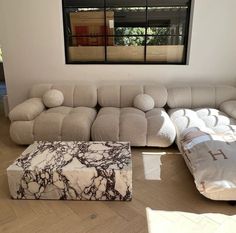 a living room filled with furniture and a large window