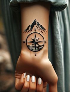 a person with a compass tattoo on their arm