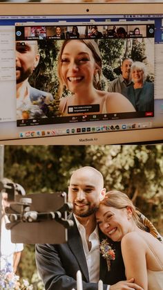 two people are hugging each other in front of a computer screen with the same image on it