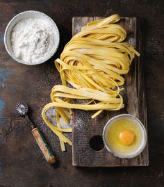 pasta and eggs on a wooden cutting board