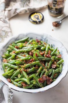 green beans in a bowl with bacon on top and the title overlay reads, german green beans low carb keto