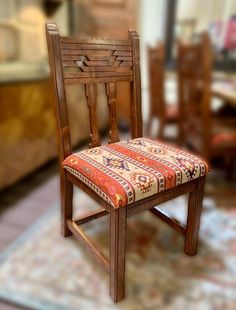 a wooden chair sitting on top of a rug