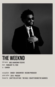 a man in a suit and tie standing next to a white poster with the words the weekend