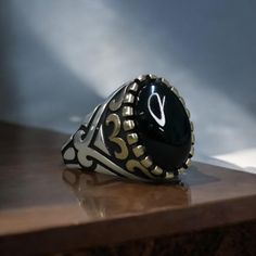 ✨ Custom Design 925 Sterling Silver Ring - Onyx Stone ✨ This sleek and elegant ring is a perfect addition to any man's jewelry collection. Meticulously handcrafted, it combines modern and vintage elements. ��💍 Features: ⚖️ Product Weight: 14g (Silver content may vary by up to 10%) 💎 Material: The ring is made of high-quality 925 sterling silver. It features a bronze detail on the top, adding extra elegance and character. 🖤 Stone: The centerpiece is adorned with a pure and eye-catching black ony Black Stone Ring, Handmade Silver Ring, Black Onyx Stone, Silver Rings Handmade, Oval Stone, Elegant Ring, Onyx Stone, Gift Jewelry, Jewelry Ring