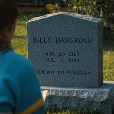 a woman standing in front of a headstone for billy hargrowe,