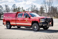 a red fire truck parked in a parking lot