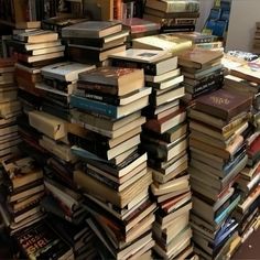 many books are stacked on top of each other