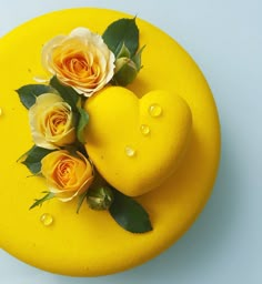 two lemons and three roses on a yellow plate with the words happy birthday in thai