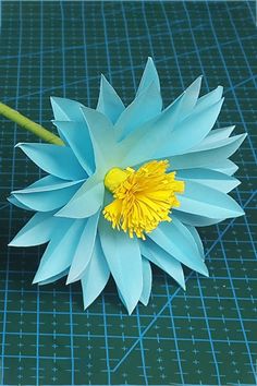 a blue flower sitting on top of a cutting board