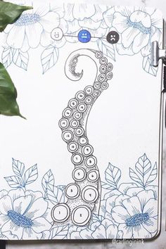 a notebook with an image of a sea horse on it and flowers in the background