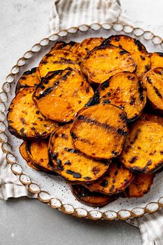 grilled sweet potato wedges on a glass platter, ready to be eaten