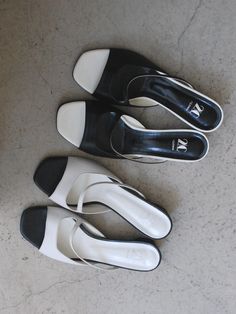 Editor's Notes2comm presents lovely and feminine footwear that is comfortable and practical. - Open square toes- Open upper with cut straps- Contrasting black & white- Wide and low heels- Classic and feminine mood Measurements (in.)- Size: KR 225MM (US 5.5) ~ KR 250MM (US 8)- Heel: 1.18 in.*Fit true to size Composition & Care- Material: Cow Leather- Natural leather may have fine scratches and wrinkles- Bright leather can get stained by denim or dark outfits- Pen and bond m White Square Toe Mules With Branded Heel, White Low Heel Mules With Heel Strap, White Sandals With Contrasting Heel And Single Toe Strap, Modern White Mules With Flat Heel, Modern White Flat Heel Mules, Modern White Flat-heeled Mules, Modern White Flat-heel Mules, Modern White Square Toe Sandals, Modern White Mules Medium Width